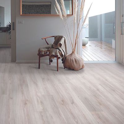 wood look laminate floors in a earth toned hallway with chair and plant